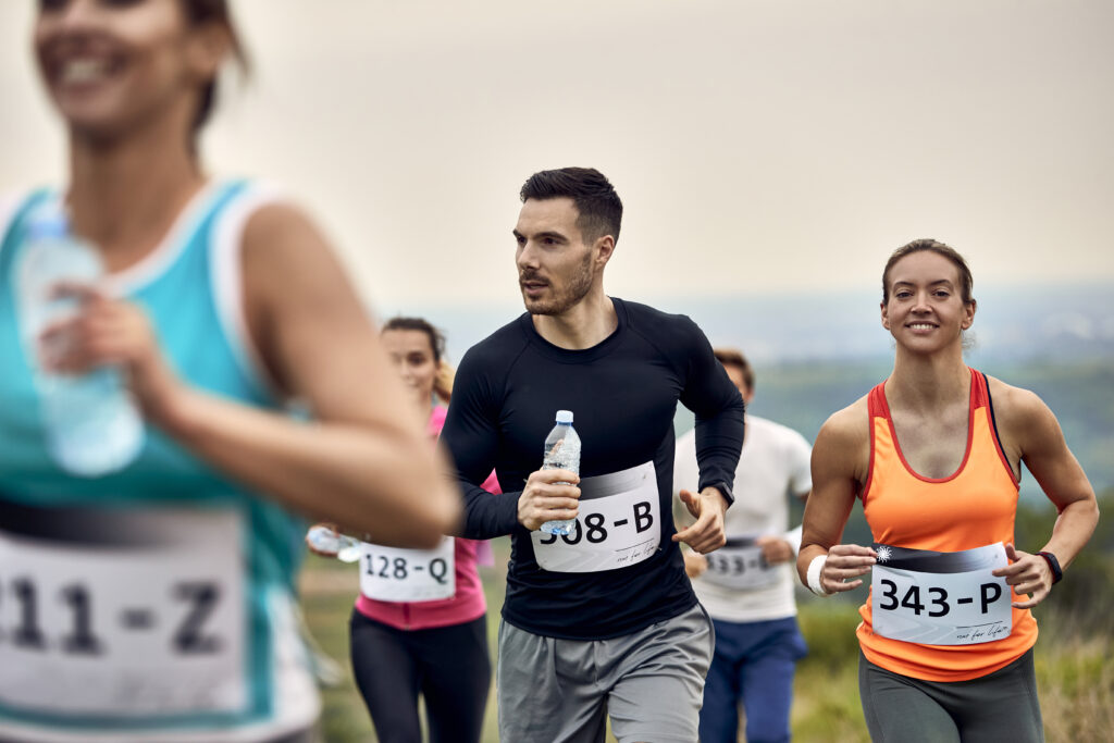 Group of athletic people taking part in cross country running.